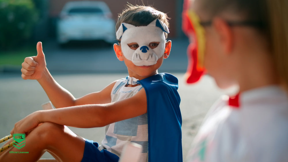 Boy wearing the Canterbury Bulldogs NRL mask and youth supporter cape