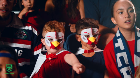 Young fans wearing the Sydney Roosters NRL mask and youth supporter cape