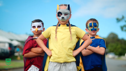 Girl wearing the North Queensland Cowboys NRL mask and youth supporter cape