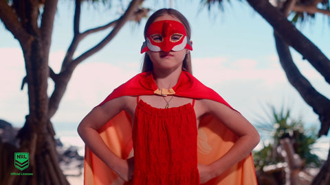 girl wearing the Dolphins NRL Mask and youth supporter cape