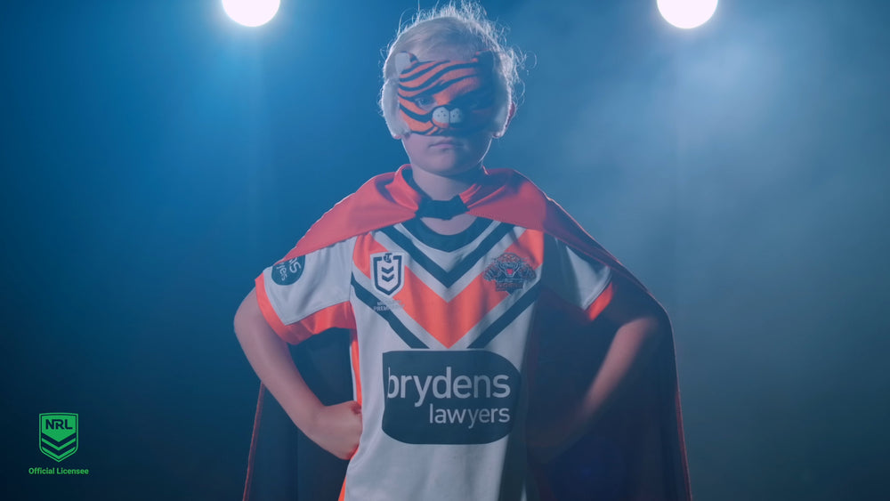 Girl wearing Wests Tiger Mask and Youth Supporter Cape with NRL Jersey