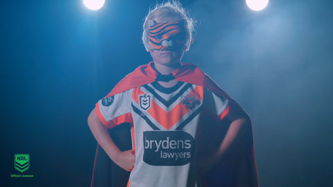Girl wearing Wests Tiger Mask and Youth Supporter Cape with NRL Jersey
