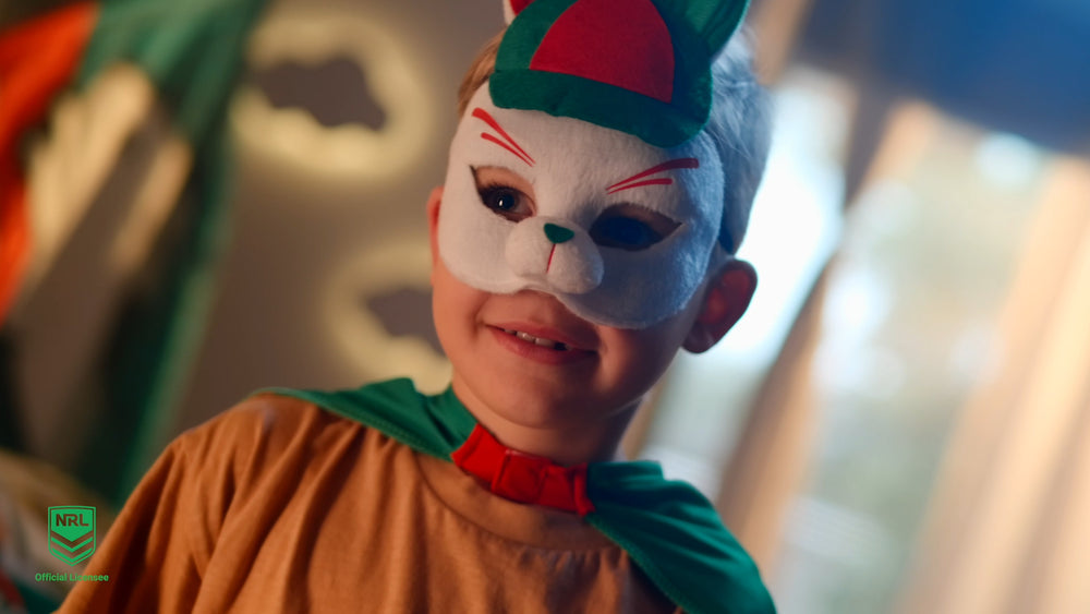 young boy wearing the South Sydney Rabbitohs NRL mask and youth supporter cape
