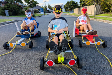 Boy wearing the Penrith Panthers NRL mask and youth supporter cape 