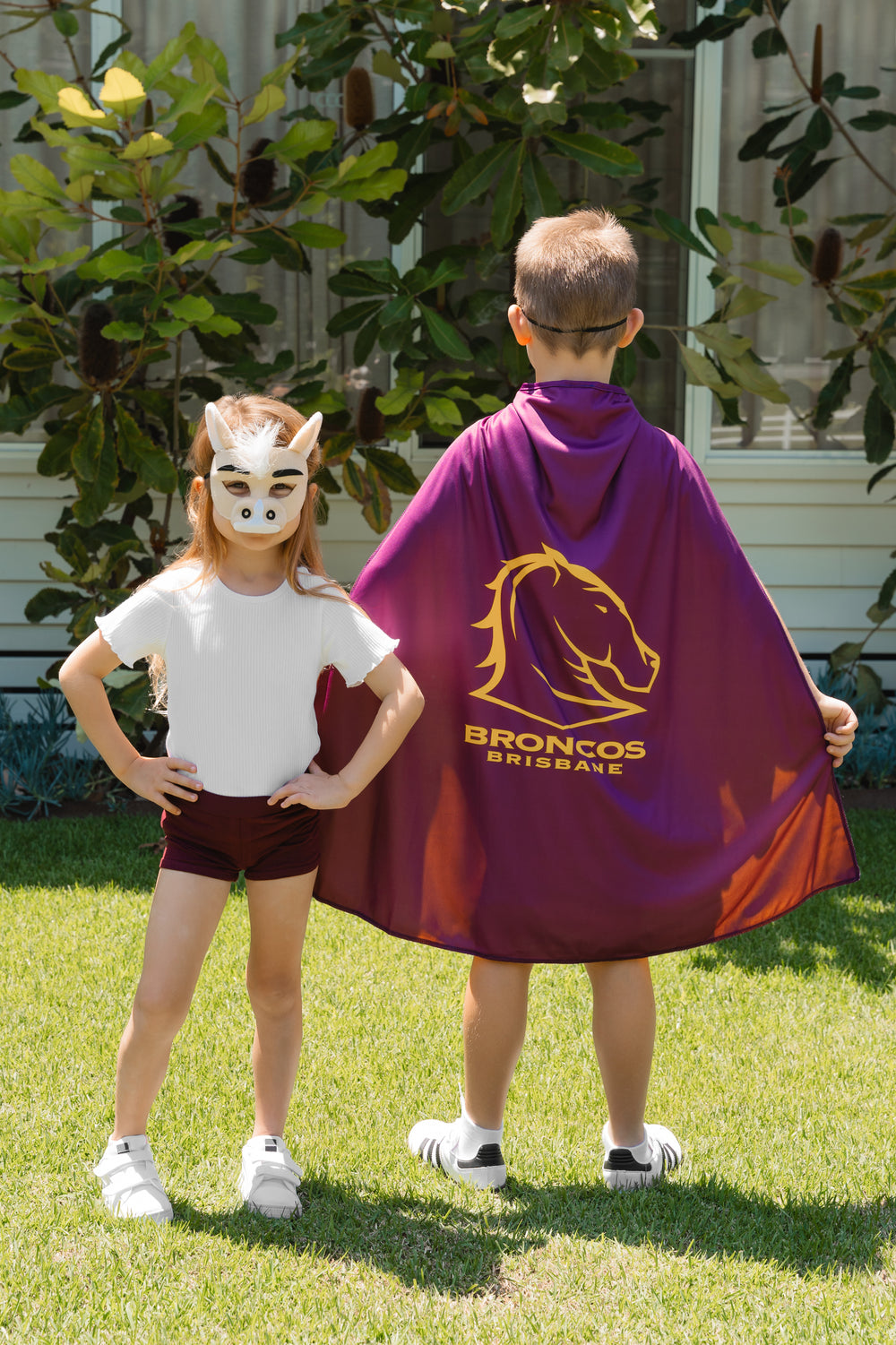 Young girl and boy wearing the Brisbane Broncos NRL Mask and Youth Supporter Cape