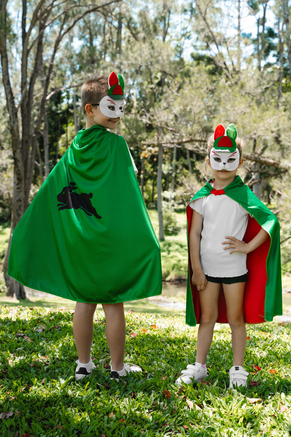 boy and girl wearing the South Sydney Rabbitohs NRL mask and youth supporter cape