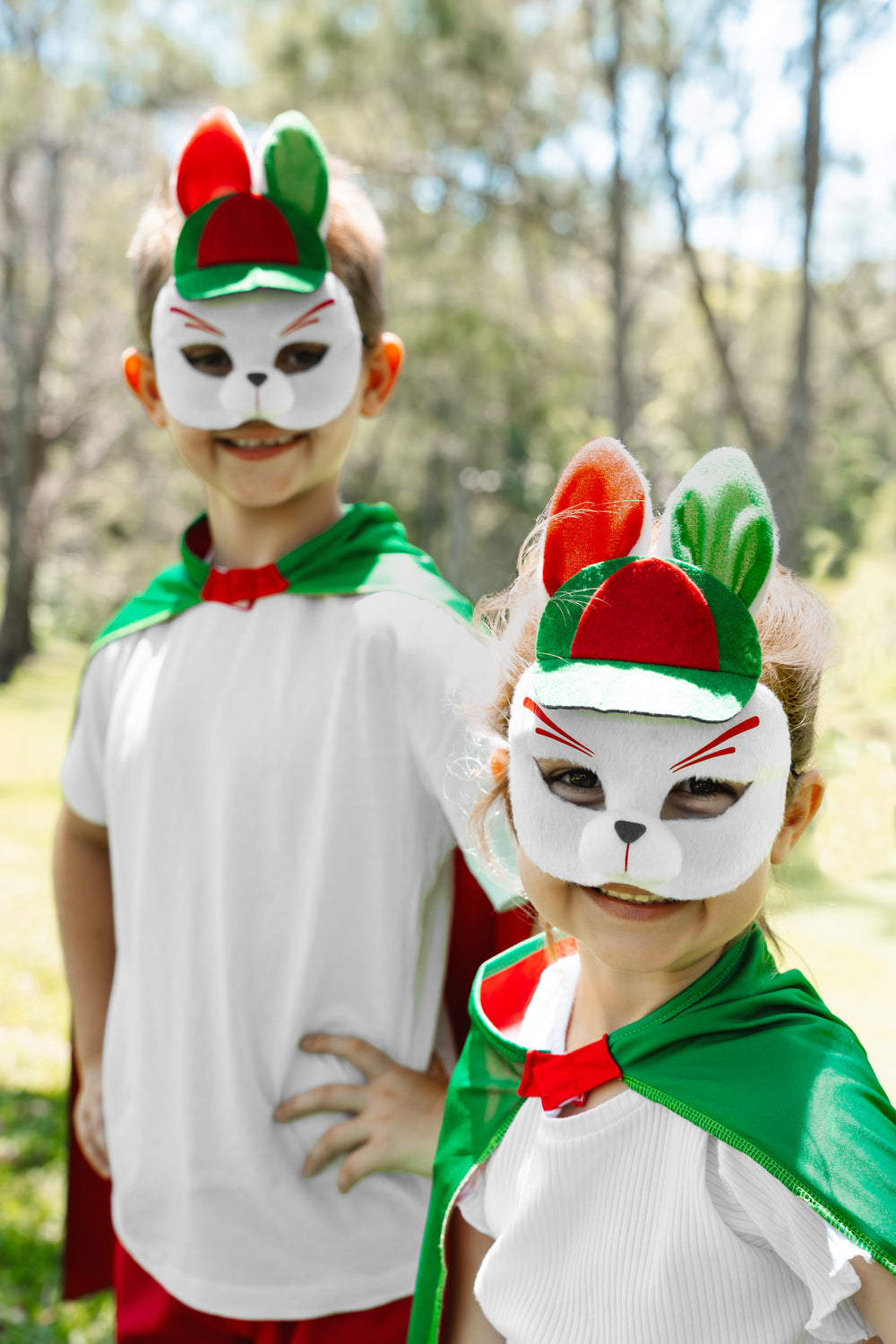 boy and girl wearing the South Sydney Rabbitohs NRL mask and youth supporter cape