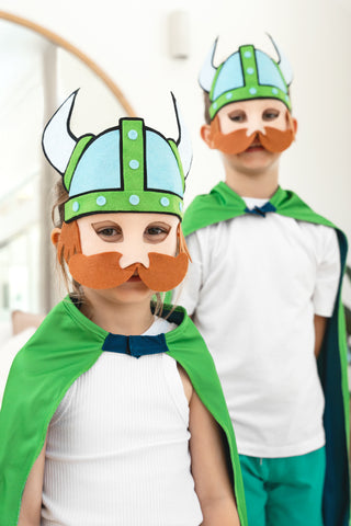 Girl and boy wearing the Canberra Raiders NRL mask and youth supporter cape
