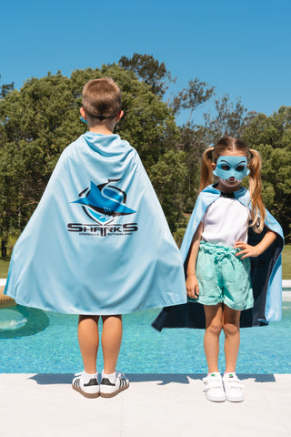 Boy and girl wearing the Cronulla Sharks NRL mask and youth supporter cape