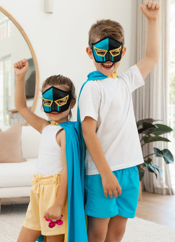 Girl and boy wearing the Gold Coast Titans NRL mask and youth supporter cape