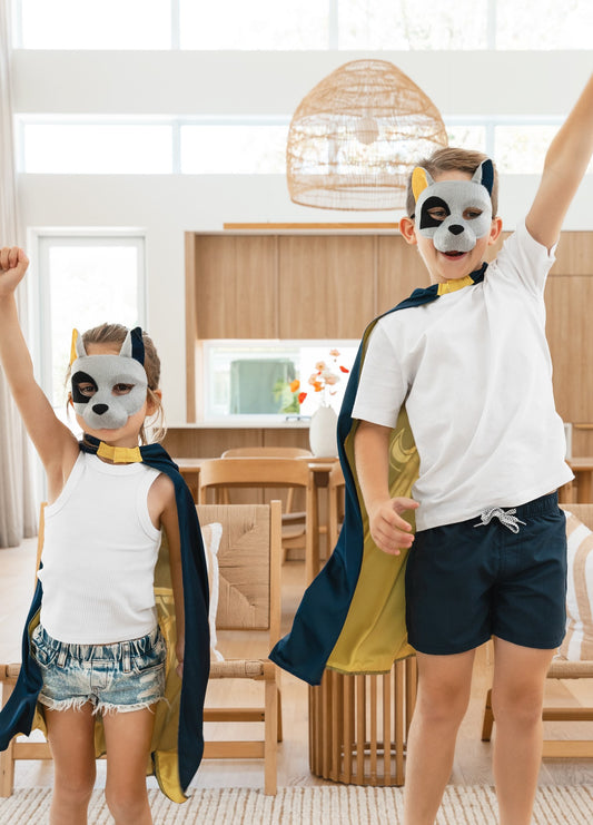 Girl and boy wearing the North Queensland Cowboys NRL mask and youth supporter cape
