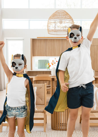 Girl and boy wearing the North Queensland Cowboys NRL mask and youth supporter cape